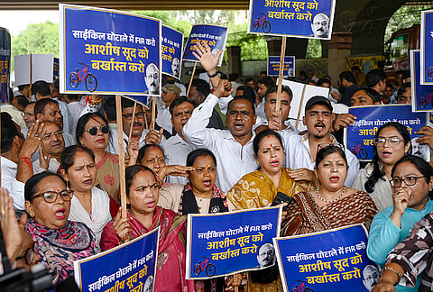 AAP leaders stage a protest near the Delhi Secretariat, demanding a probe by the Delhi government into the alleged bicycle scam, in New Delhi.