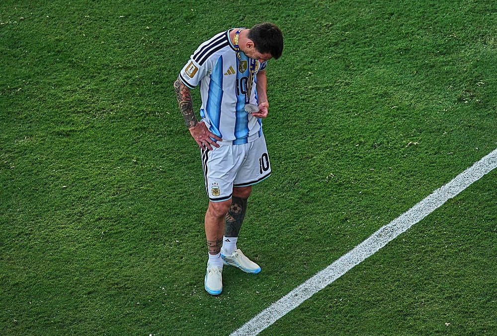 Argentinas Lionel Messi (10) checks his runners-up medal after the World Cup final soccer match between Spain and Argentina in East Rutherford, N.J., near New York, July 19, 2026.