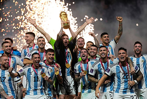 Argentina's Lionel Messi lifts the trophy after winning the World Cup final soccer match between Argentina and France in Lusail, Qatar, Dec. 18, 2022. Argentina won 4-2 in a penalty shootout after the match ended tied 3-3. 
