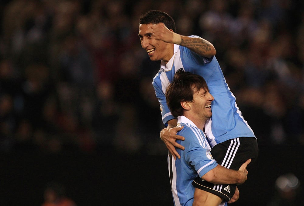 Argentinas Angel Di Maria, top, celebrates with Argentinas Lionel Messi after scoring against Ecuador during a World Cup 2014 qualifying soccer game in Buenos Aires, June 2, 2012. 