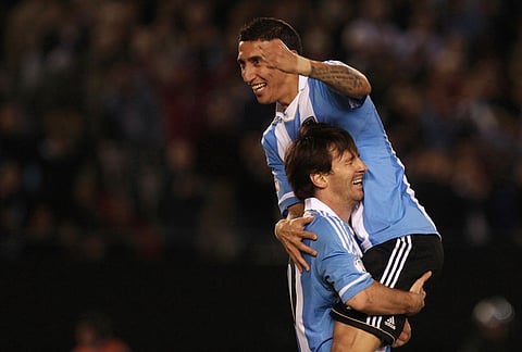 Argentina's Angel Di Maria, top, celebrates with Argentina's Lionel Messi after scoring against Ecuador during a World Cup 2014 qualifying soccer game in Buenos Aires, June 2, 2012. 