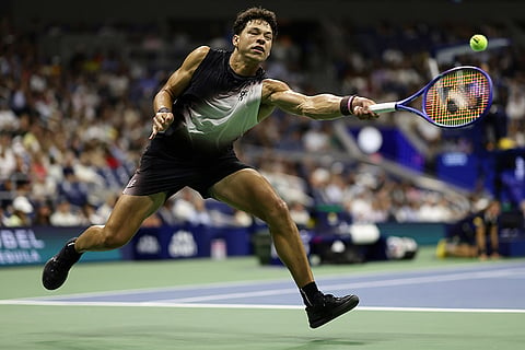 Ben Shelton, of the United States, returns the ball to Tallon Griekspoor, of the Netherlands, during the first round of the U.S. Open tennis championships in New York.