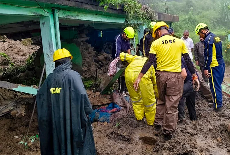 Debris swept into a house following rain in Almora