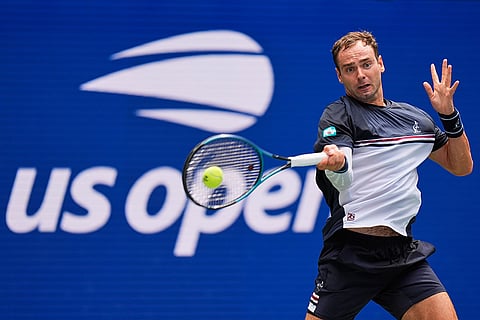 Roman Safiullin, of Russia, returns the ball to Carlos Alcaraz, of Spain, during the first round of the U.S. Open tennis championships in New York.