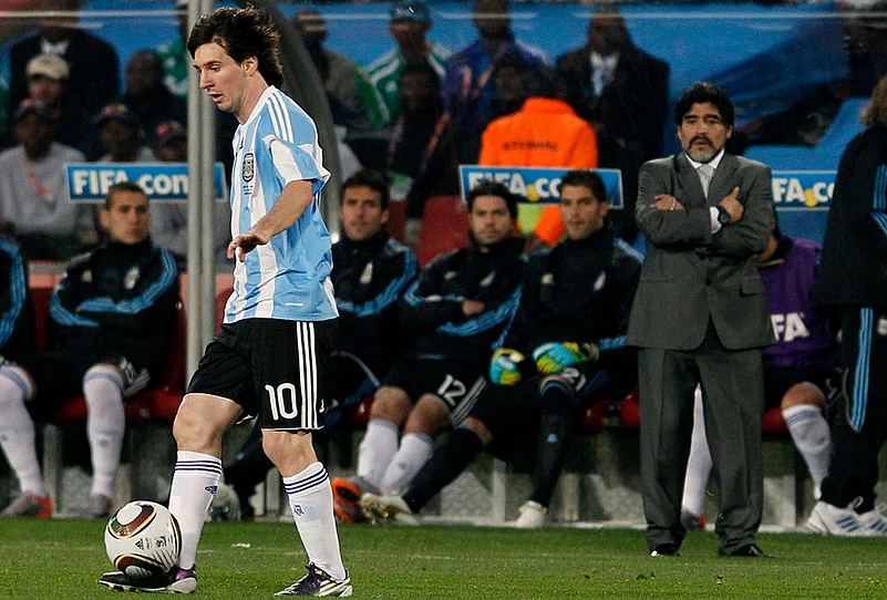 Argentina head coach Diego Maradona, right, looks at Argentinas Lionel Messi, left, as he controls the ball during the World Cup group B soccer match against Nigeria in Johannesburg, South Africa, Saturday, June 12, 2010.