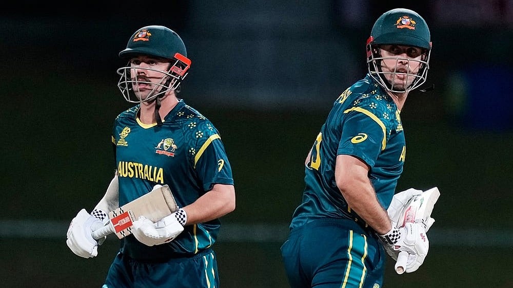 Australia's Travis Head and captain Mitchell Marsh run between the wickets during the T20 World Cup cricket match between Australia and Oman in Pallekele, Sri Lanka. - | Photo: AP/Eranga Jayawardena