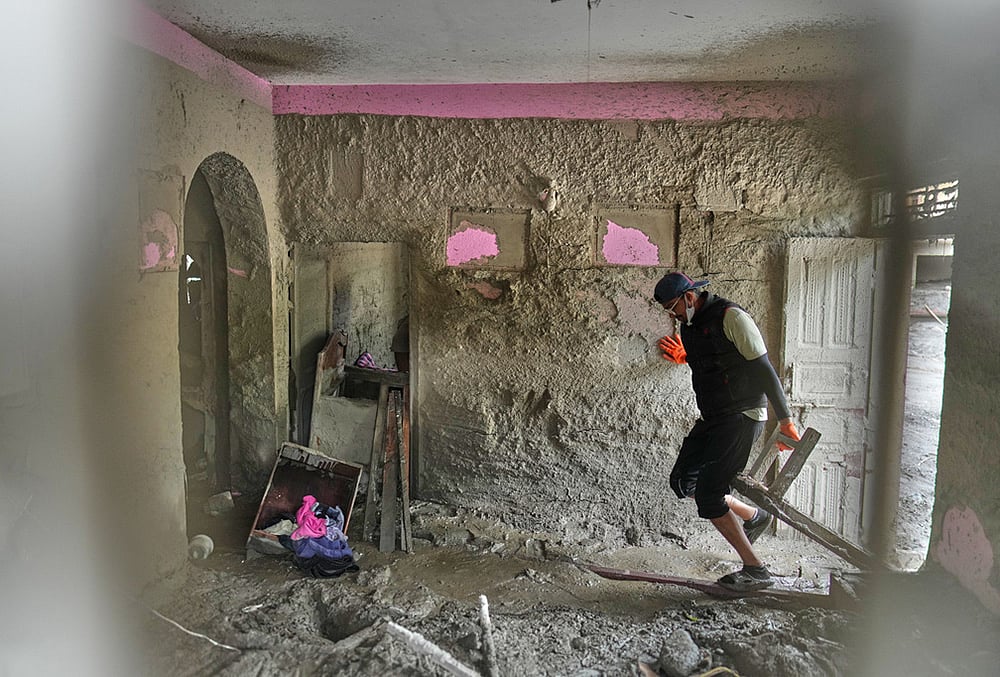 A resident salvages usable material from his house damaged by flash flooding at 1 Number Pul, in Nepal's Nuwakot district, Tuesday, Sept. 1, 2026.  - | Photo: AP/Rajesh Kumar Singh