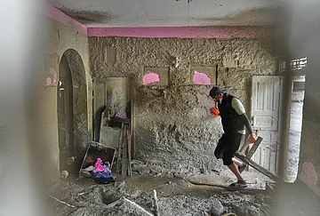 | Photo: AP/Rajesh Kumar Singh : A resident salvages usable material from his house damaged by flash flooding at 1 Number Pul, in Nepal's Nuwakot district, Tuesday, Sept. 1, 2026.