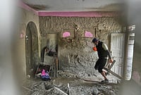 In Photos: Nepal Flood Survivors Salvage Belongings From The Ruins | Photo: AP/Rajesh Kumar Singh : A resident salvages usable material from his house damaged by flash flooding at 1 Number Pul, in Nepal's Nuwakot district, Tuesday, Sept. 1, 2026.