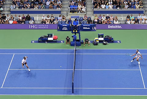 Fans watch Lorenzo Sonego, right, of Italy, play Alexander Zverev, of Germany, in the first round of the U.S. Open tennis championships Tuesday, Sept. 1, 2026, in New York. 