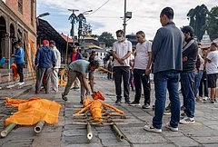 Family members of victims prepare effigies made of hay and straw for their last rites after the bodies were not recovered following the recent flash floods, at the Pashupatinath Temple premises, in Kathmandu, Nepal. The death toll from Nepal's devastating flash floods rose to 1,127 on Wednesday as rescuers are racing to find thousands still missing a week after the Himalayan disaster, police said. - | Photo: PTI/Abhishek Maharjan