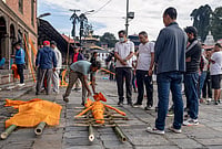 | Photo: PTI/Abhishek Maharjan : Family members of victims prepare effigies made of hay and straw for their last rites after the bodies were not recovered following the recent flash floods, at the Pashupatinath Temple premises, in Kathmandu, Nepal. The death toll from Nepal's devastating flash floods rose to 1,127 on Wednesday as rescuers are racing to find thousands still missing a week after the Himalayan disaster, police said. 