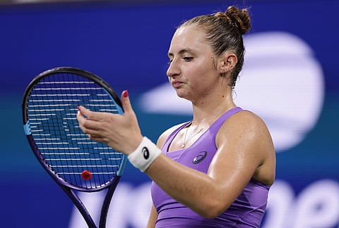Mary Stoiana, of the United States, adjusts the strings in her racket during her match against Alexandra Eala, of the Philippines, in the first round of the U.S. Open tennis championships Tuesday, Sept. 1, 2026, in New York. 