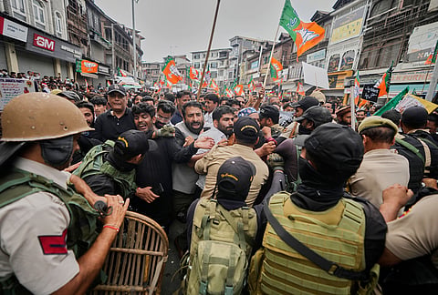 Police and paramilitary soldiers try to stop activists of Bharatiya Janata Party (BJP) during a protest against the National Conference (NC)-led regional government over rising electricity tariffs, unemployment and alleged governance failures in Srinagar, Indian-controlled Kashmir, Wednesday, Sept. 2, 2026. 