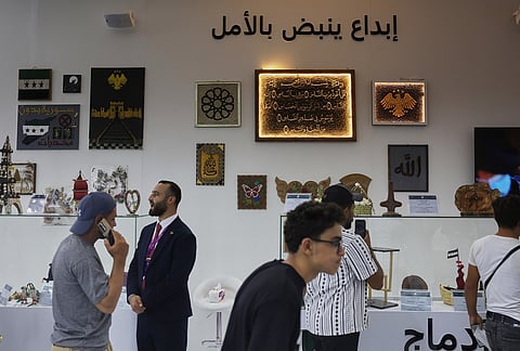 Visitors browse a display of artwork and handicrafts said to have been made by inmates currently held in Syrian prisons at the 63rd Damascus International Fair on the outskirts of Damascus, Syria, Monday, Aug. 31, 2026. 