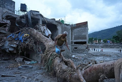 A resident salvages belongings from his damaged home after flash flooding in the Devighat area of Nuwakot district in Nepal, Monday, Aug. 31, 2026.