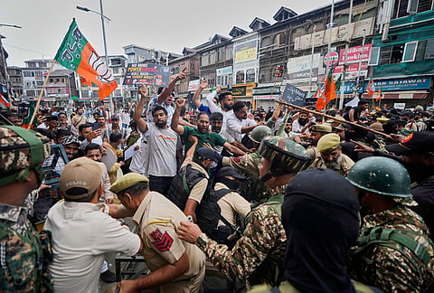Activists of Bharatiya Janata Party (BJP) shout slogans as police and paramilitary soldiers try to stop them during a protest against the National Conference (NC)-led regional government over rising electricity tariffs, unemployment and alleged governance failures in Srinagar, Indian-controlled Kashmir, Wednesday, Sept. 2, 2026. 