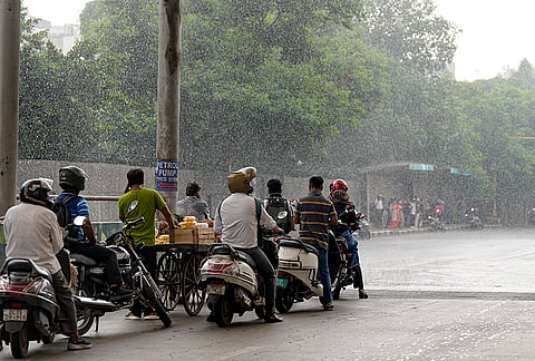 People take shelter under a foot over bridge amid rainfall, at Mathura Road, in New Delhi, Wednesday, Sept. 2, 2026. 