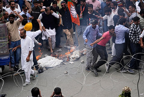 Bharatiya Janata Party (BJP) activists pull a barbed wire barrier set up by police to stop them during a protest against the National Conference (NC)-led regional government over rising electricity tariffs, unemployment and alleged governance failures in Srinagar, Indian-controlled Kashmir, Wednesday, Sept. 2, 2026. 