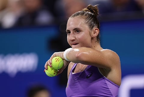 Mary Stoiana, of the United States, wipes her chin during her match against Alexandra Eala, of the Philippines, during the first round of the U.S. Open tennis championships Tuesday, Sept. 1, 2026, in New York.