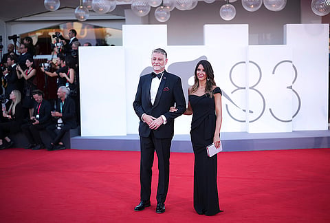 Minister of Culture of Italy Alessandro Giuli, left, and Valeria Falcioni pose for photographers at the opening ceremony and the red carpet for the film 'Ink' during the 83rd edition of the Venice Film Festival in Venice, Italy, on Wednesday, Sept. 2, 2026. 