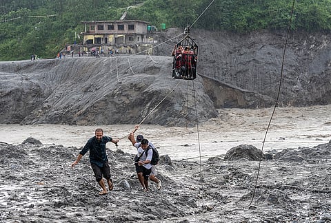 Residents pull a newly installed zipline to help people commute across the Trishuli river in the aftermath of flash floods at Bidur in Nepal's Nuwakot district, Nepal, Wednesday, Sept. 2, 2026.