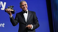 George Clooney Receives Honorary Golden Lion At Venice Film Festival, Rebukes Authoritarians In Powerful Speech (Photo by Scott A Garfitt/Invision/AP) : George Clooney poses with the golden lion for lifetime achievement during the opening ceremony of the 83rd edition of the Venice Film Festival in Venice, Italy, on Wednesday, Sept. 2, 2026.