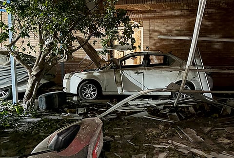 Debris surrounds a car at the site of what Iranian media said was a U.S. strike in Kuhestak, southern Iran, early Wednesday, Sept. 2, 2026. 