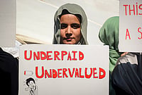 In Photos: J-K Medical Interns Stage Protest Over Low Stipend, Suspend Work | Photo: PTI : An intern doctor holds a placard reading 'Underpaid Undervalued' during a protest demanding an enhancement of their monthly internship stipend, in Srinagar, Thursday, Sept. 3, 2026.