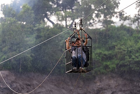Residents commute across the Trishuli river on a newly installed zipline in the aftermath of flash floods at Bidur in Nepal's Nuwakot district, Nepal, Wednesday, Sept. 2, 2026. 