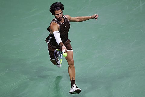 Carlos Alcaraz, of Spain, returns the ball to Jaime Faria, of Portugal, during the second round of the U.S. Open tennis championships in New York.