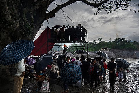 Residents wait for their turn commute across the Trishuli river on a newly installed zipline in the aftermath of flash floods at Bidur in Nepal's Nuwakot district, Nepal, Wednesday, Sept. 2, 2026. 