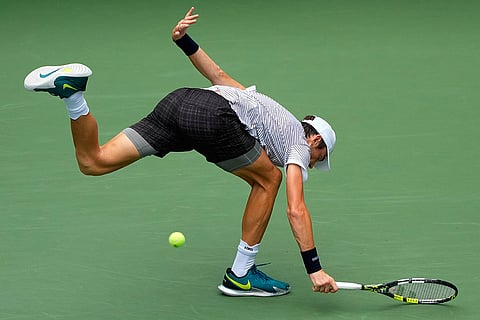 Sebastian Gorzny, of the United States, falls as he attempts to return the ball to Daniil Medvedev, of Russia, during the second round of the U.S. Open tennis championships in New York.