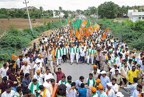 Karnataka BJP State President BY Vijayendra, center, along with party leaders and workers leads the 3rd day of the 'Ballari Chalo Padayatra' demanding the implementation of irrigation projects and protesting against the state government, at Gudadur village, in Koppal district, Karnataka.
