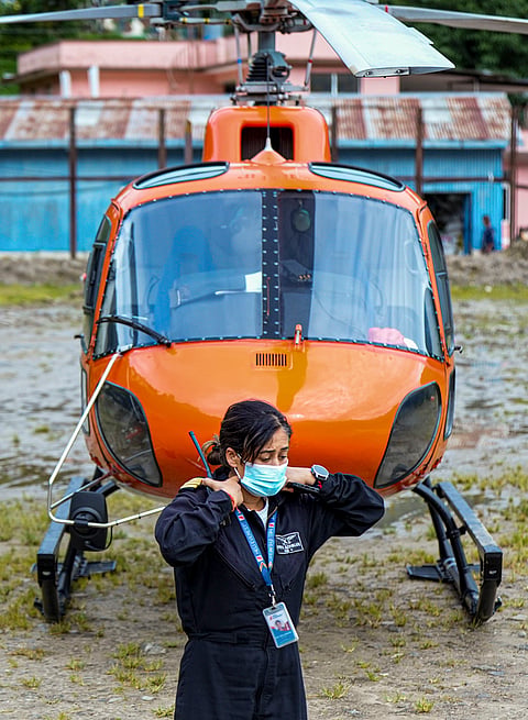 Nepal’s first female helicopter Captain Priya Adhikari during relief and rescue operations after the flash floods, in Rasuwa, Nepal. She reportedly has flown around 100 rescue missions in less than a week. 