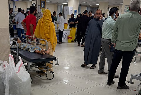 People gather at a hospital as a child wounded, according to Iranian media, in a U.S. strike that hit a home where a wedding was being held in Kuhestak, southern Iran, waits for treatment at left in Minab, Iran, early Wednesday, Sept. 2, 2026. 
