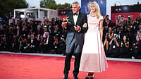 | Photo: Scott A Garfitt/Invision/AP : George Clooney, left, recipient of the golden lion for lifetime achievement and Laura Dern pose for photographers during the 83rd edition of the Venice Film Festival in Venice, Italy, on Wednesday, Sept. 2, 2026. 