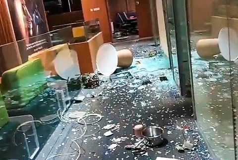 A screengrab from a video shared by TMC leader Abhishek Banerjee shows shattered glass on the floor after an intrusion at his Camac Street office. 