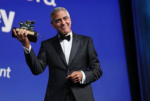 George Clooney poses with the golden lion for lifetime achievement during the opening ceremony of the 83rd edition of the Venice Film Festival in Venice, Italy, on Wednesday, Sept. 2, 2026. 