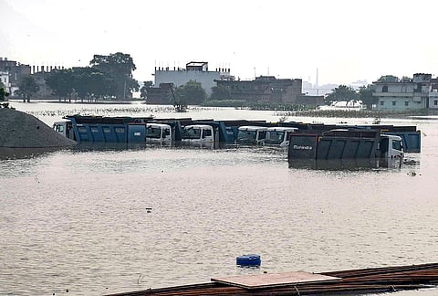Heavy vehicles remain partially submerged in floodwaters following the rise in the water level of the Ganga river, in Patna, Bihar, Friday, Sept. 4, 2026. 
