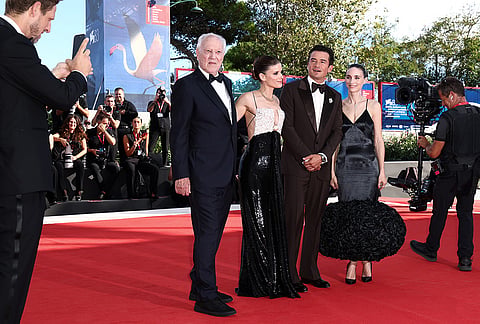 Producer Ariel Leon Isacovitch, from left, takes a photograph of director Werner Herzog, Kate Mara, Orlando Bloom and Rooney Mara at the red carpet for the film 'Bucking Fastard' during the 83rd edition of the Venice Film Festival in Venice, Italy, on Thursday, Sept. 3, 2026. 