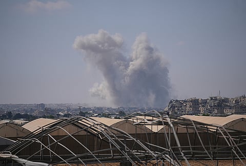 The Israeli army demolishes buildings east of Khan Younis, in the southern Gaza Strip.