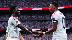 Real Madrid's Kylian Mbappe, right, celebrates with Real Madrid's Vinicius Junior after scoring his sides third goal during the La Liga soccer match between Real Madrid and Malaga in Madrid. - Manu Fernandez/AP Photo