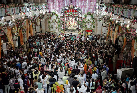 People offer prayers during the 'Janmashtami' festival, at Shri Krishna Janmasthan temple, in Mathura, Uttar Pradesh.