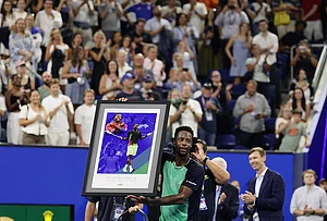 | Photo: AP/Adam Hunger : Gael Monfils, of France, holds up a gift presented to him after his match against Learner Tien, of the United States, in the second round of the U.S. Open tennis championships, Thursday, Sept. 3, 2026, in New York.