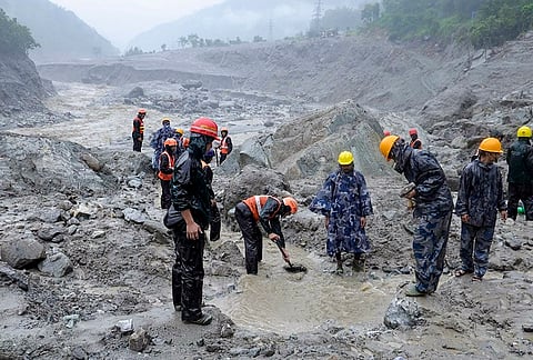 In this image posted on Aug. 29, 2026, Rescue efforts continue for the second day to evacuate people reportedly trapped inside a tunnel of the Trishuli 3 ‘A’ Hydropower Project, with teams working to clear the debris blocking its entrance, in Rasuwa. 