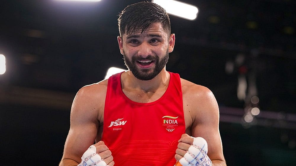India's Sachin Siwach celebrates after winning the men's 60kg final boxing bout against Namibia's Tryagain Morning Ndevelo, unseen, at the 23rd Commonwealth Games (CWG), in Glasgow, Scotlan. Siwach bagged gold in the event. - Photo: PTI/Ravi Choudhary