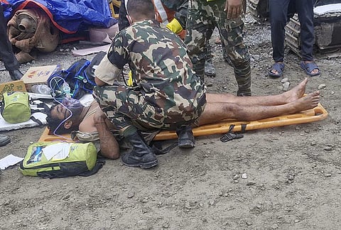 In this image received on Sept. 4, 2026, Nepal army personnel give first aid to a man rescued from the tunnel of the Trishuli 3A Hydropower Project, in the aftermath of the recent flash floods, in Rasuwa district. 