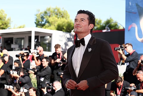 Orlando Bloom poses for photographers at the red carpet for the film 'Bucking Fastard' during the 83rd edition of the Venice Film Festival in Venice, Italy, on Thursday, Sept. 3, 2026. 