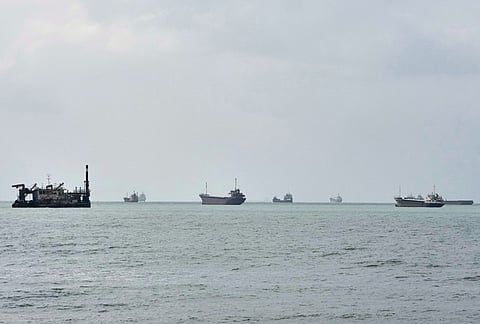 Commercial vessels are anchored in the Strait of Hormuz off Bandar Abbas, Iran.